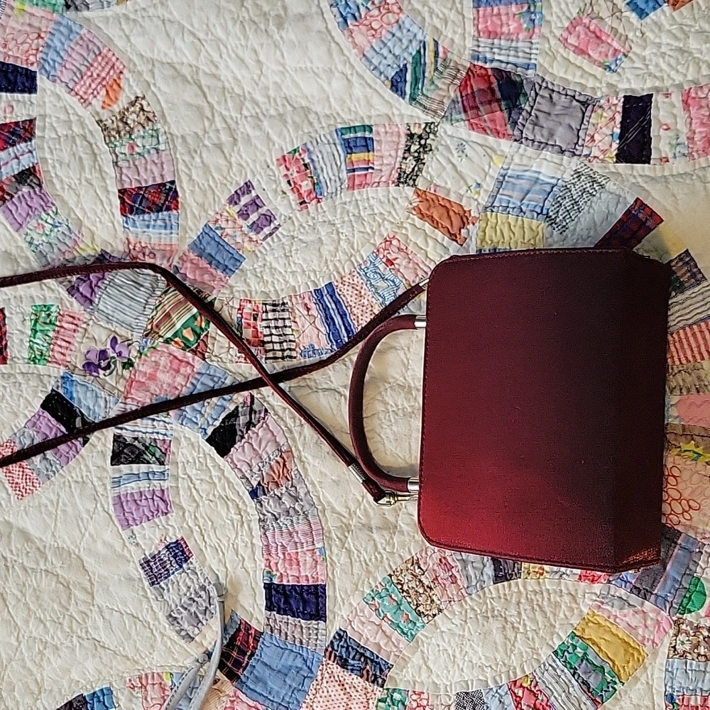 Burgundy clutch cross body attachment